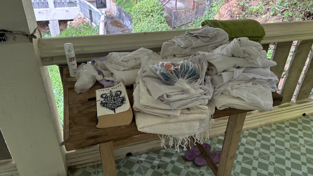 the table of white Vipassana clothing left behind my other meditators