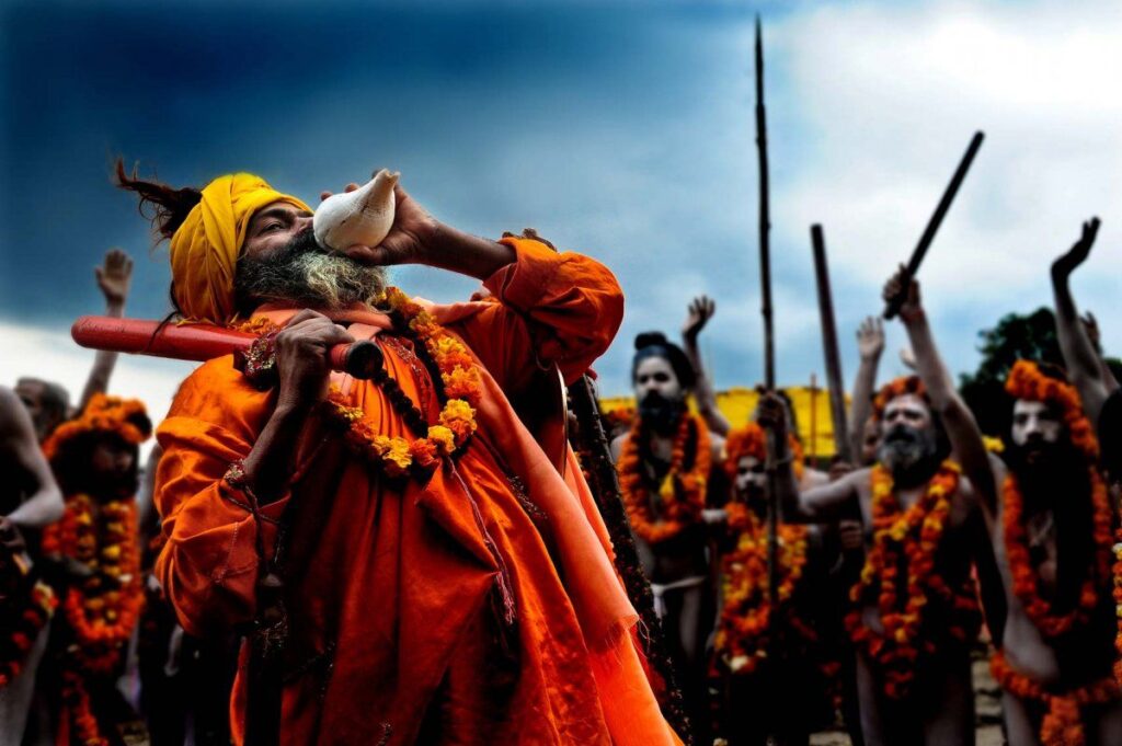 Seen here is a saint blowing a conch shell during Mahakumbh